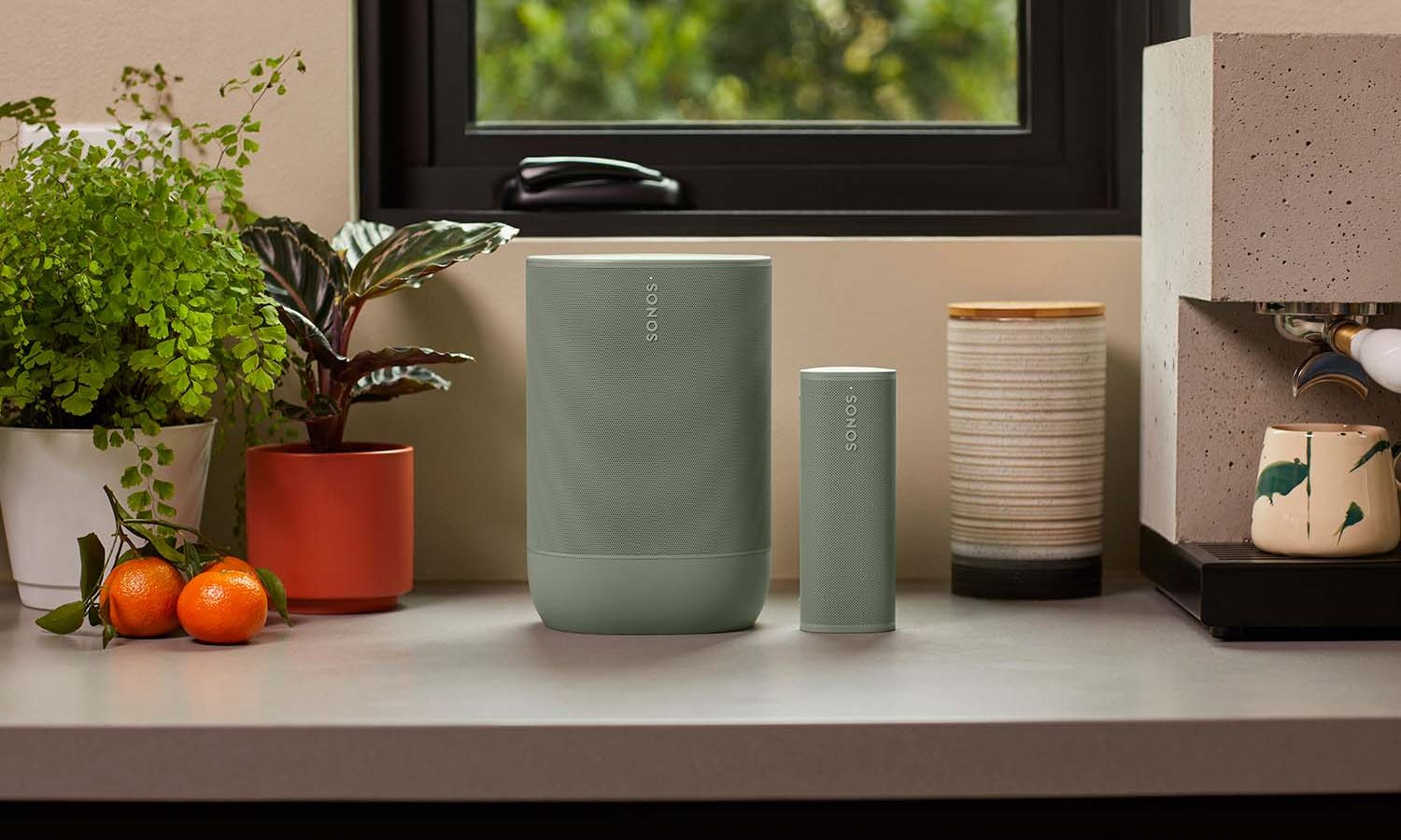 Sonos speakers sitting on console table and sonos sub on floor