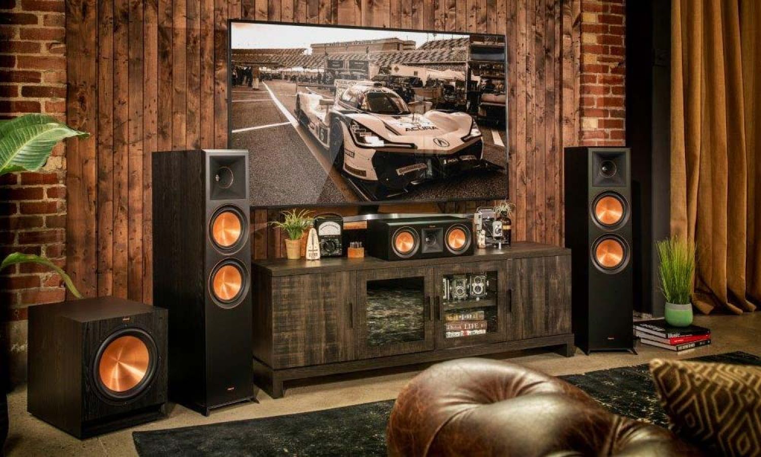 Klipsch speakers next to console table under tv