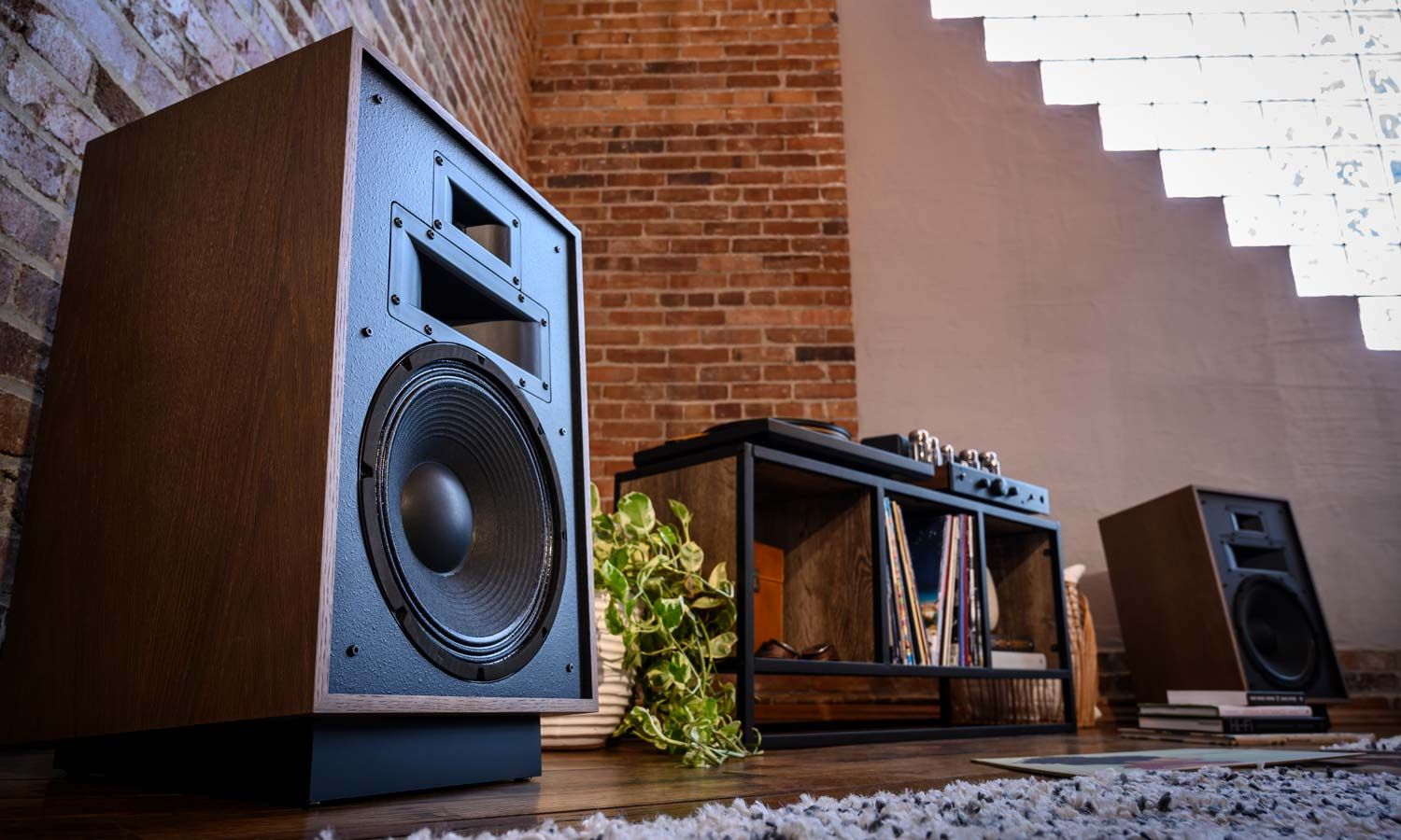 Klipsch speakers next to console table under tv