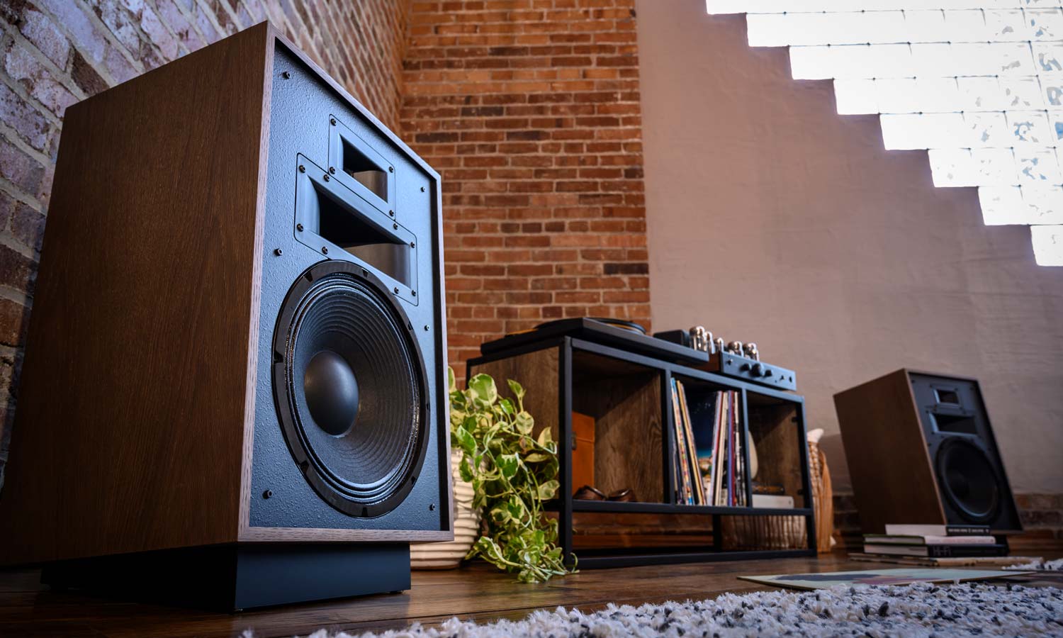 Klipsch speakers next to console table under tv