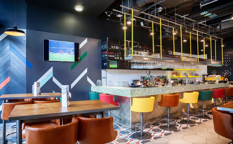 a bar with a wall-mounted TV showing a sports channel