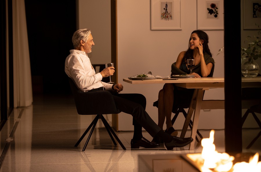two people sitting in a dining room having dinner.