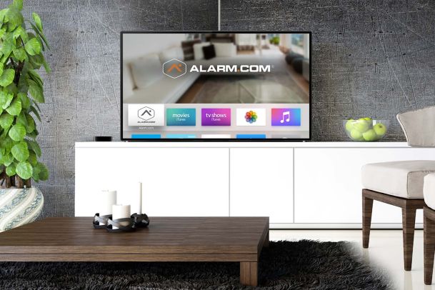 Apple TV with alarm.com on it on white console table