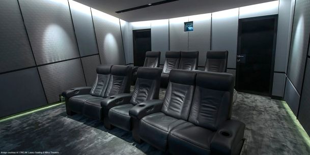 Home theater with black seating and grey walls