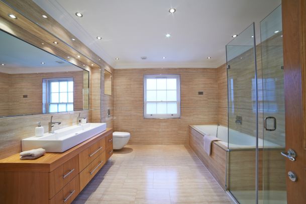 Bathroom with LED lighting in ceiling and tan tiling